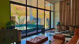 Glass-walled living area overlooking the pool